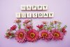 happy-tuesday-alphabet-letters-pink-flower-decoration-purple-background-171650116.jpg