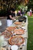 a-long-wedding-pizza-table-with-pizzas-on-metal-trays-that-warm-up-the-food-and-dips-and-sauces.jpg